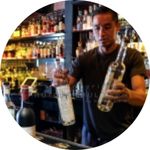 Photo of bartender holding bottles